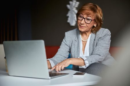 senior female working on her laptop