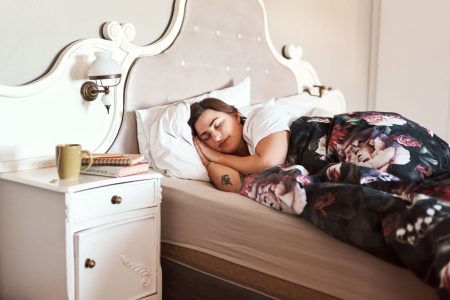 woman happily sleeping in bed