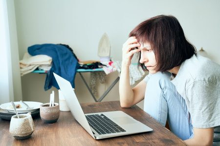 woman having anxiety in front of her laptop