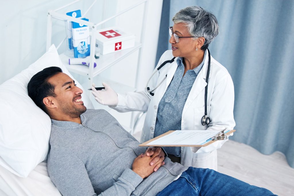 man-doctor-and-medical-test-with-stethoscope female doctor checking on male patient