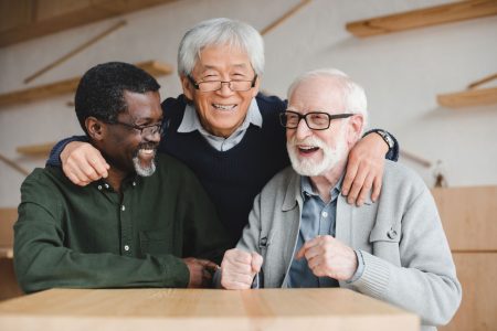 older adult friends embracing